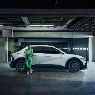 A person is leaning against the right rear door of the IONIQ 5 N DK Edition vehicle.